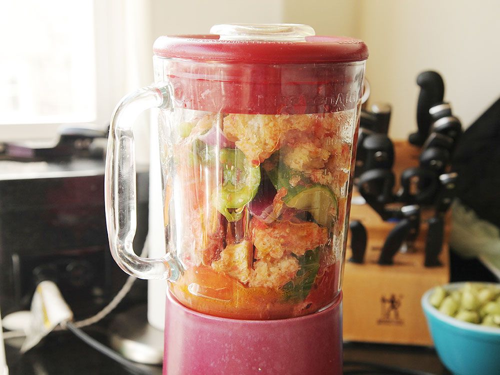 Gazpacho ingredients in chunks about to be blended in a blender.