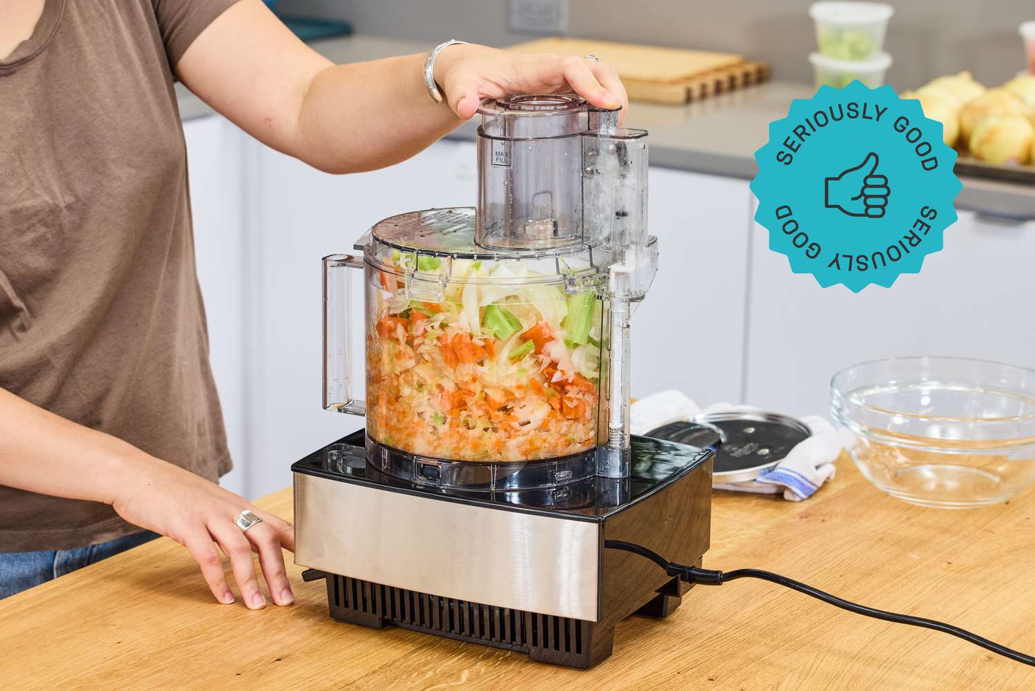 A person using a food processor to make mirepoix.