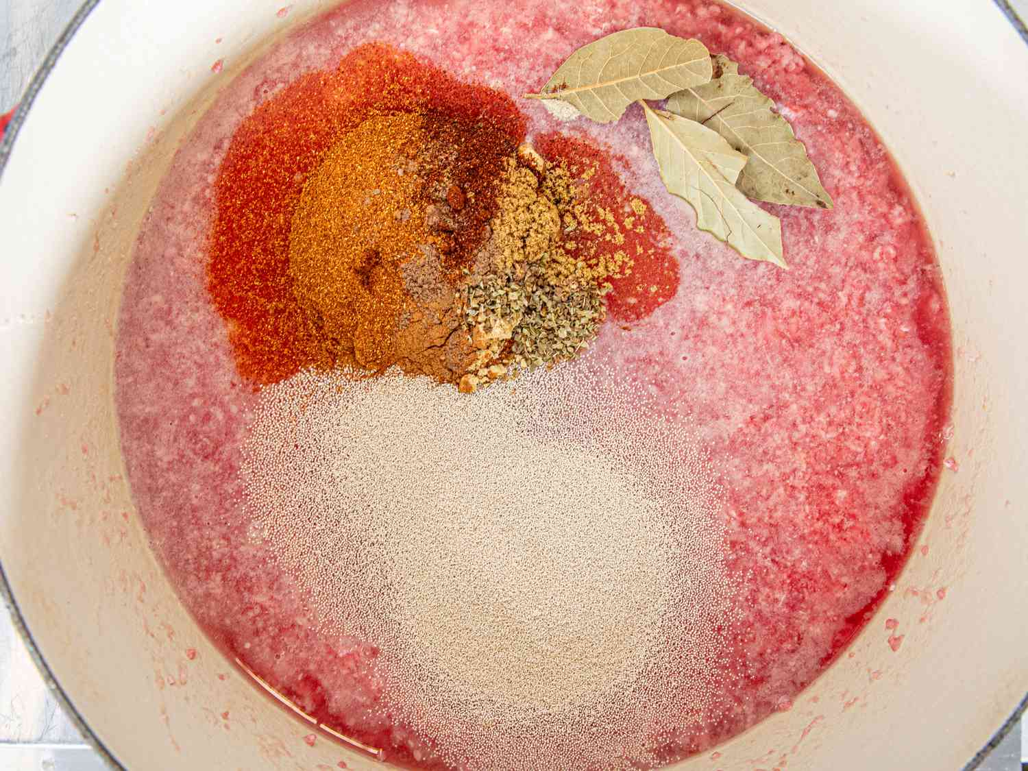 Overhead view of seasoning and yeast added to the chili