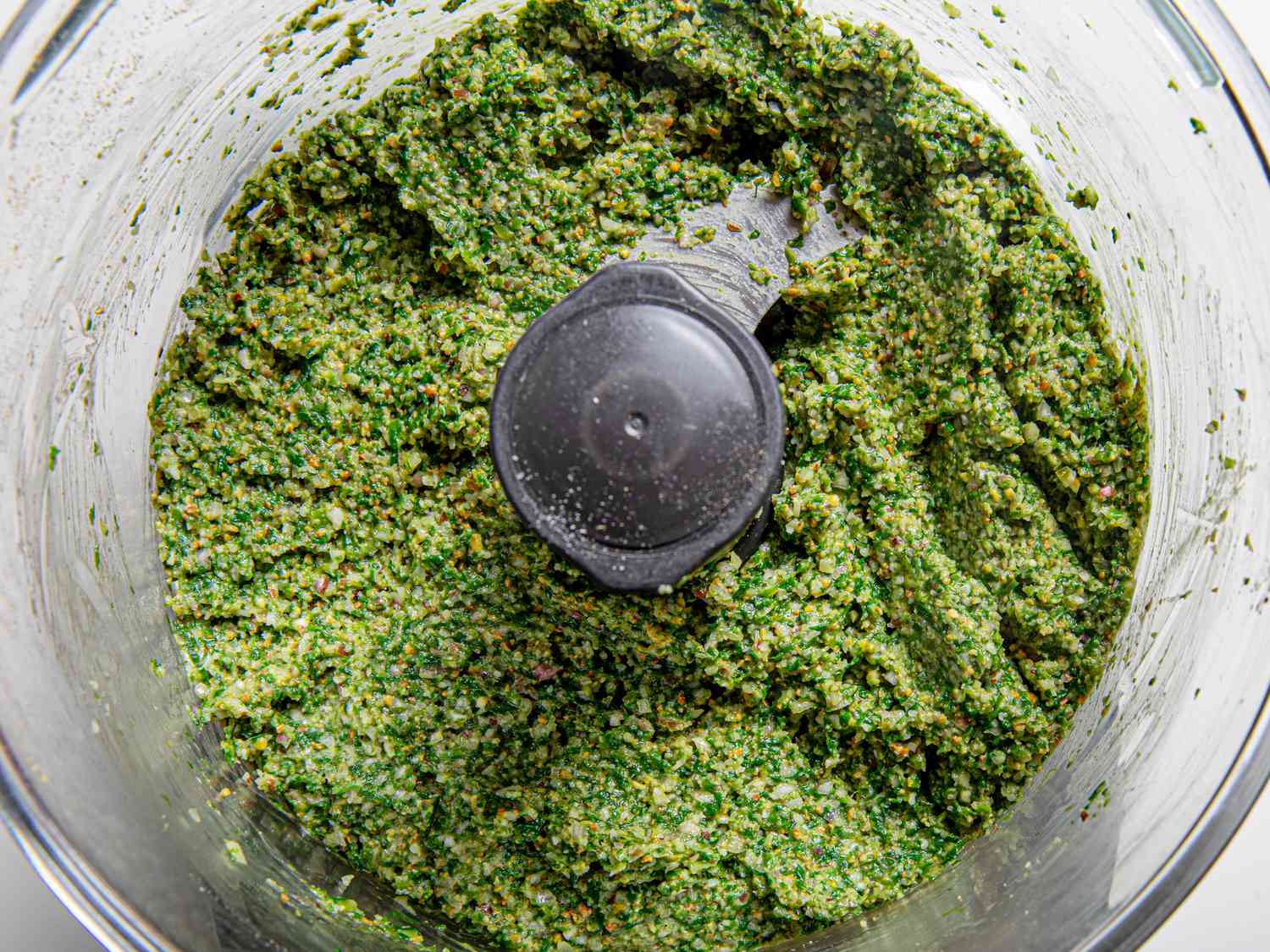 Overhead view of pesto in food processor