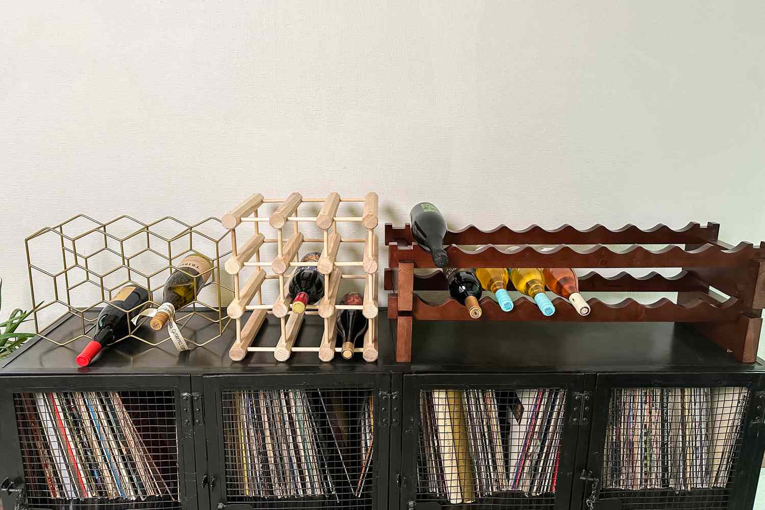 Three wine racks sitting on top of a cabinet.