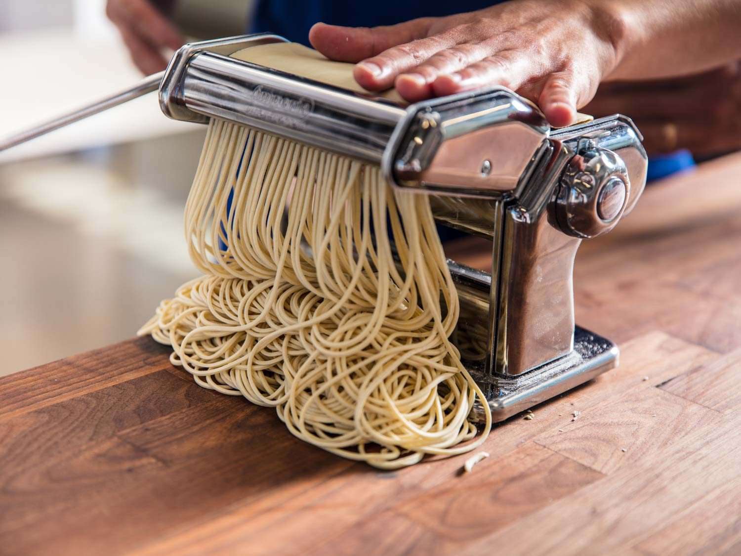 Pasta cutter cutting ramen dough sheets into noodles