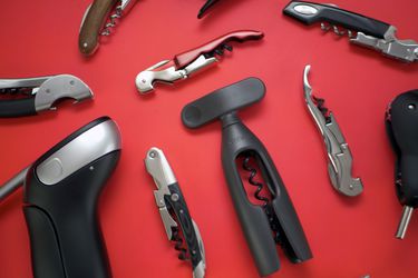assorted wine openers on a red background