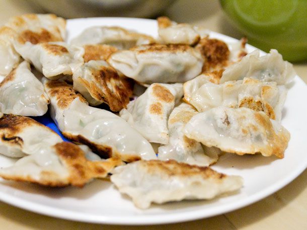 A plate filled with browned dumplings.