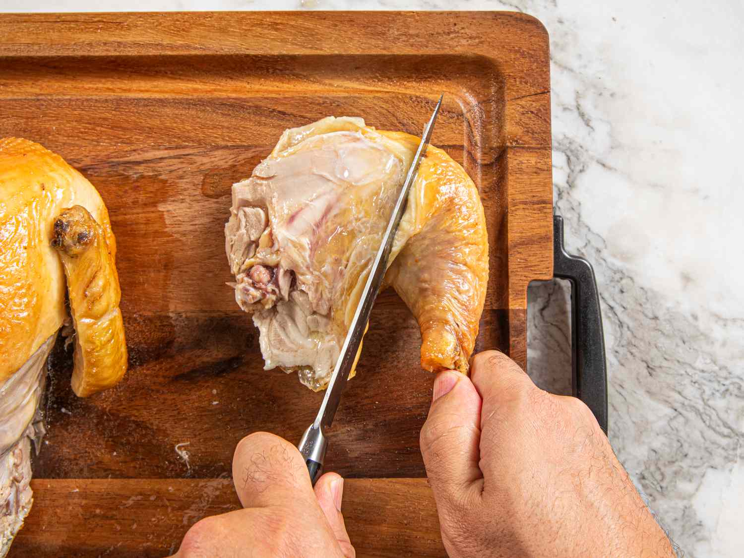 Overhead view of seperating the leg from the thigh