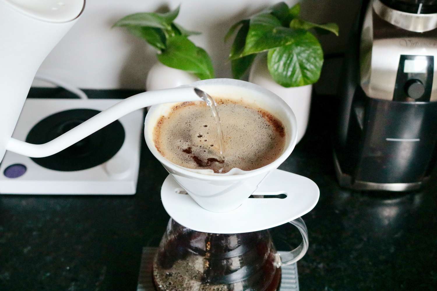 Pouring water into a pour-over coffee maker