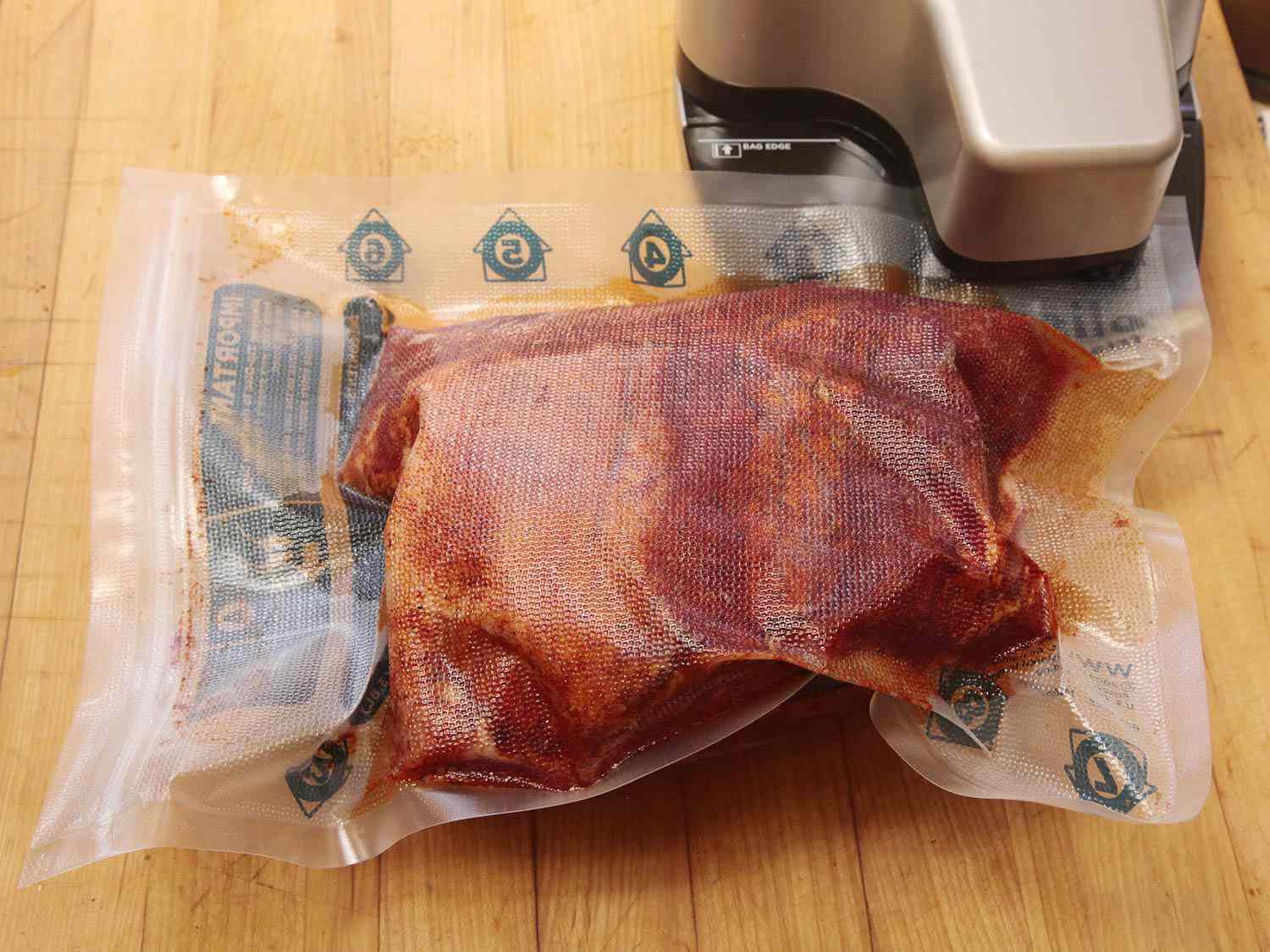 raw pork shoulder being vacuum-sealed 