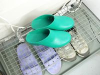 Calzuro clogs on a wire shoe rack.