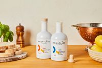 Two bottles of Brightland olive oil on a kitchen countertop.