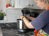a person placing an attachment in the ooni