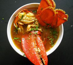 Overhead of lobster in yellow curry sauce. 