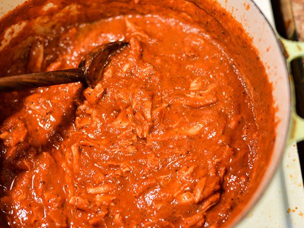Shredded meat is added back to the pan.