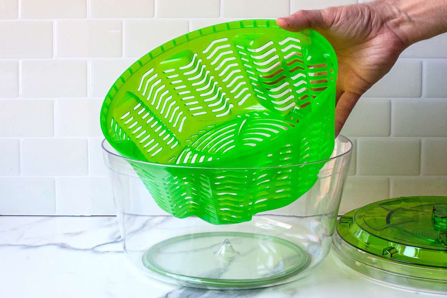 a person removing the basket on the zyliss spinner