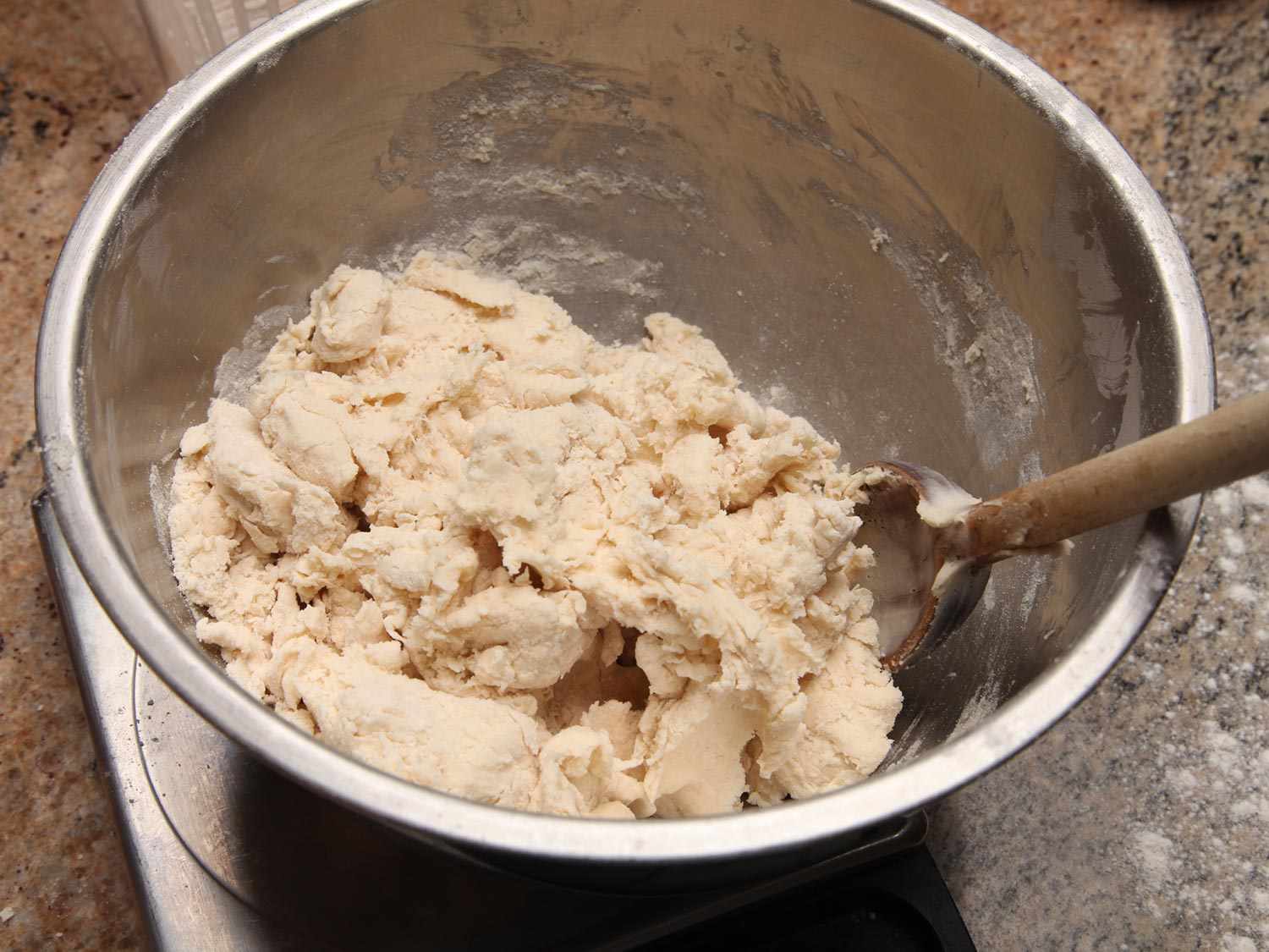 A shaggy dough for two-ingredient biscuits in a mixing bowl.