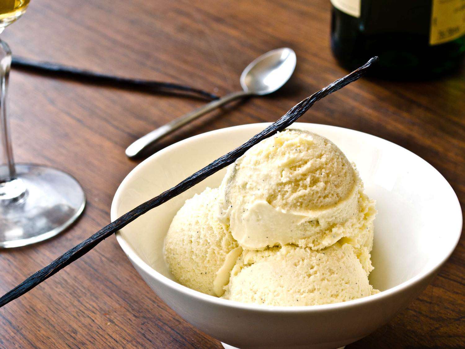 A bowl holding three scoops of Scotch vanilla bean ice cream.