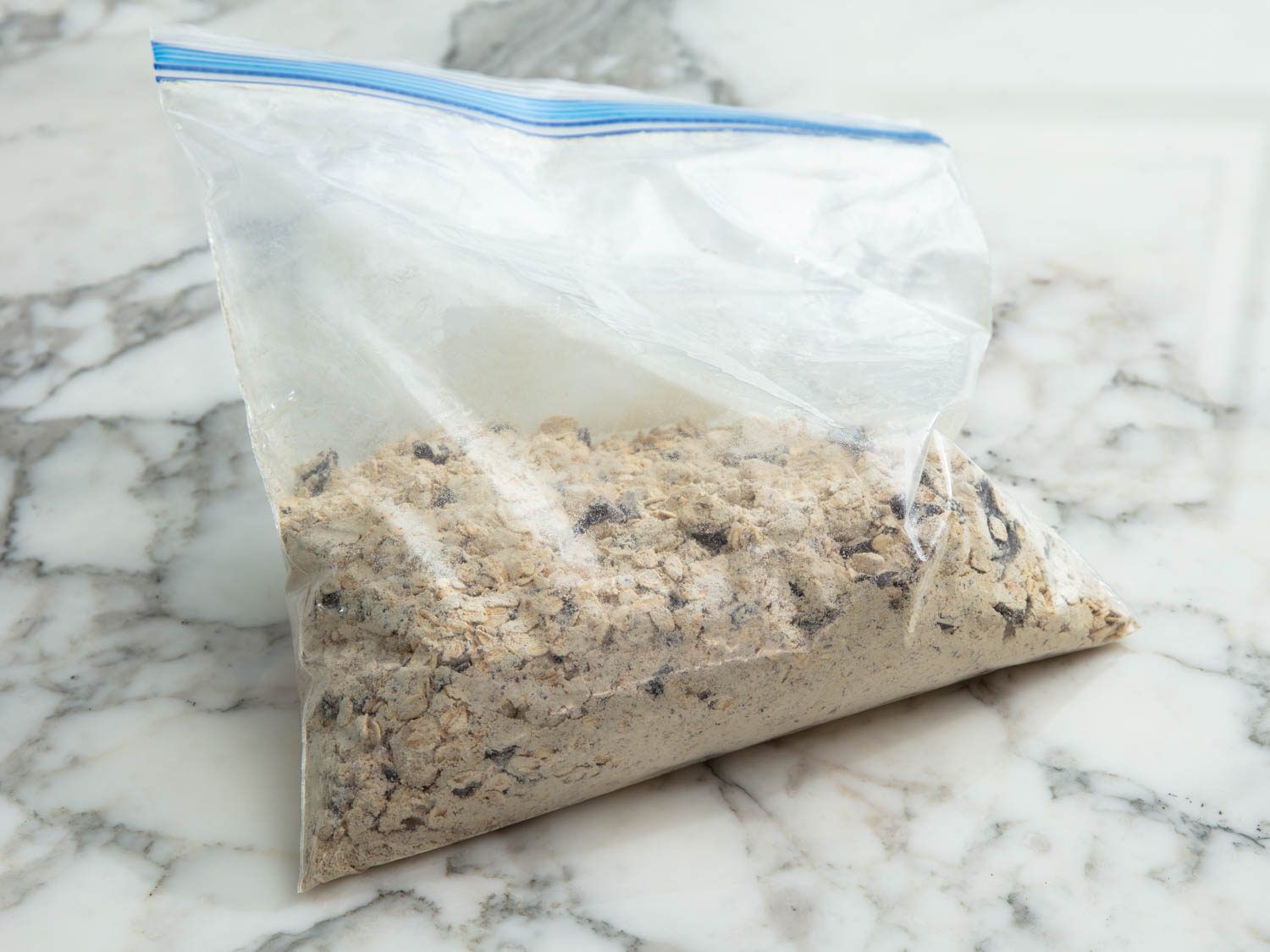 The prepared dry mix for lactation cookies stored in a large, zip-top bag.