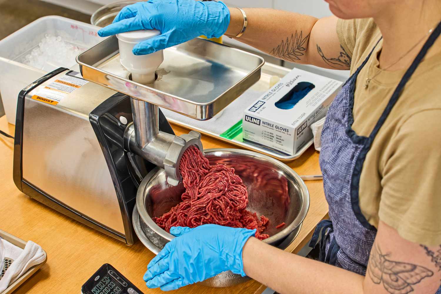 Person holding bowl of grind meat from Weston #8 Electric Meat Grinder