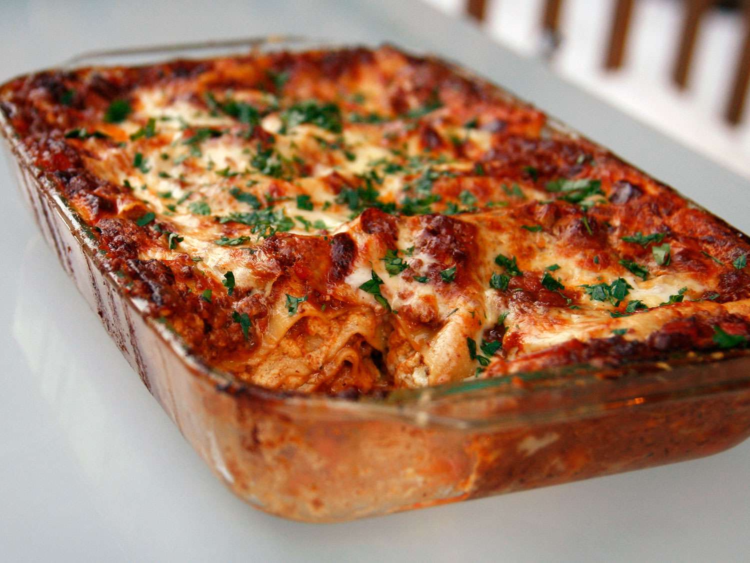 Lasagna bolognese in a glass baking dish