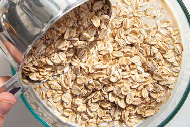 Overhead view of dumping oats into a bowl 