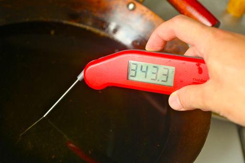 Testing oil temperature with an instant-read thermometer.