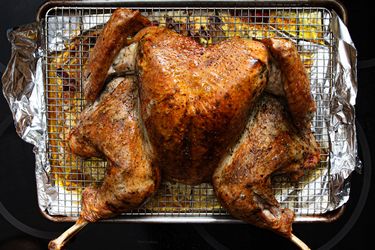 Roasted spatchcock turkey on a wire rack over a baking sheet cooked and ready for serving
