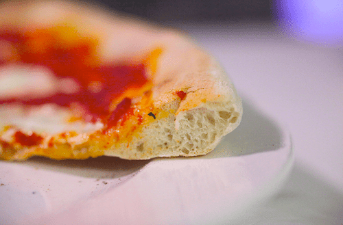 The interior of a homemade Neapolitan-style pizza, looking dense. 