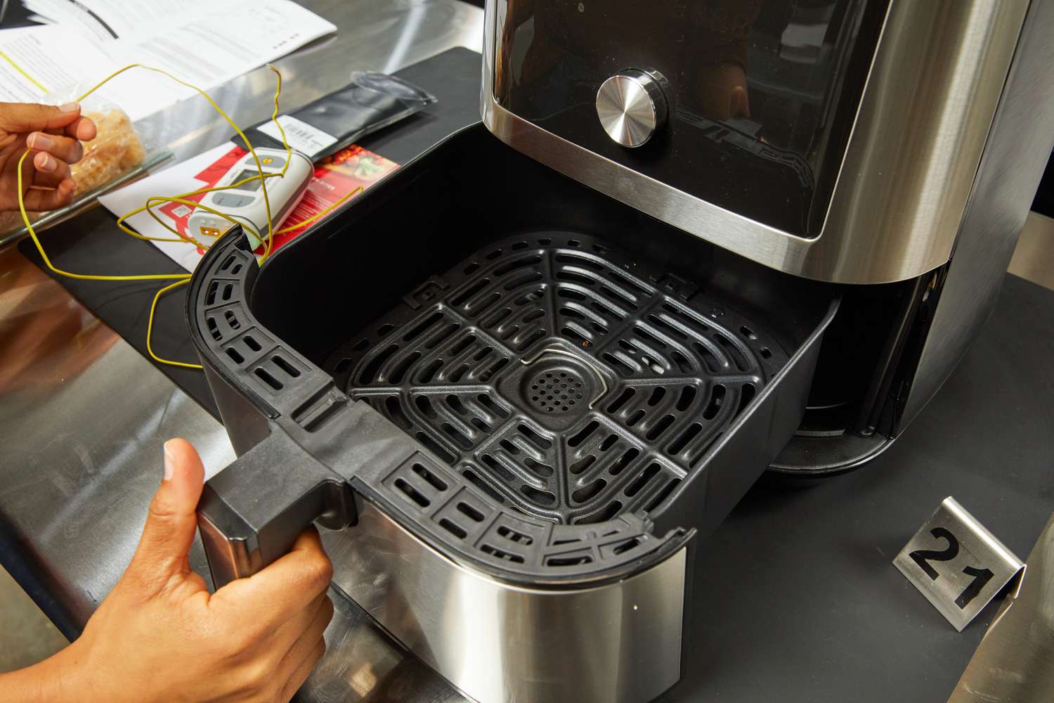 Hand putting the basket in the Instant Pot Vortex Plus 6-Quart 6-in-1 Air Fryer