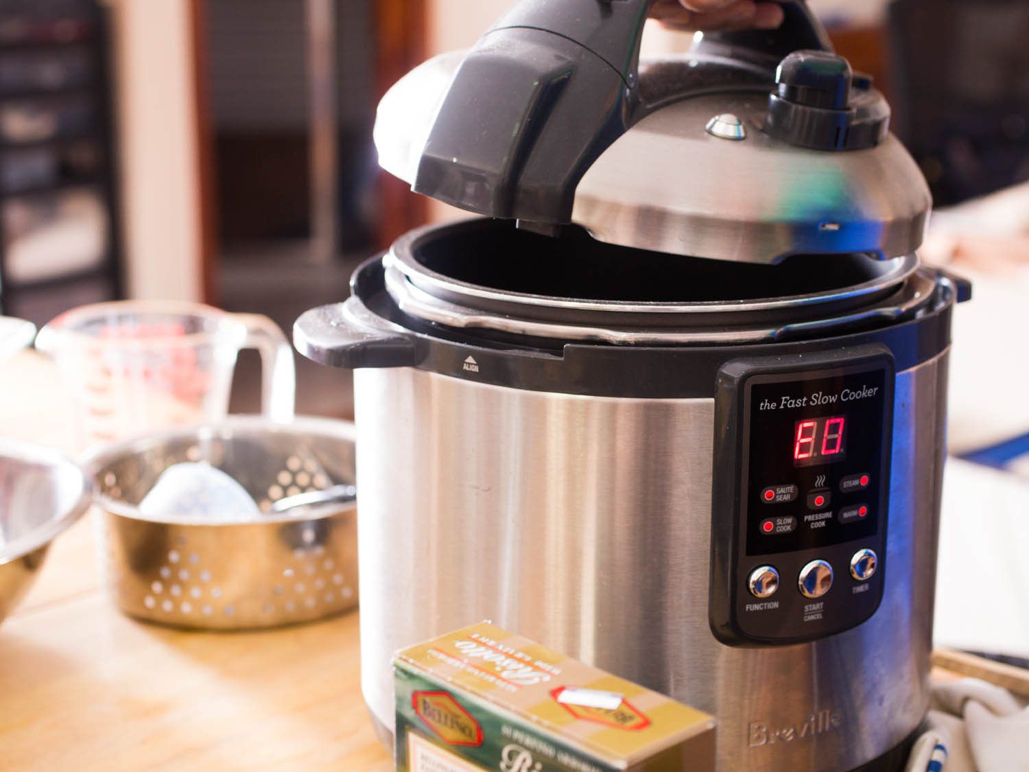 Lid being put on pressure cooker for butternut squash risotto.