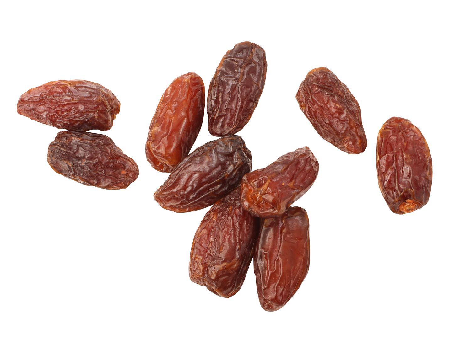 Several Medjool dates scattered against a white background