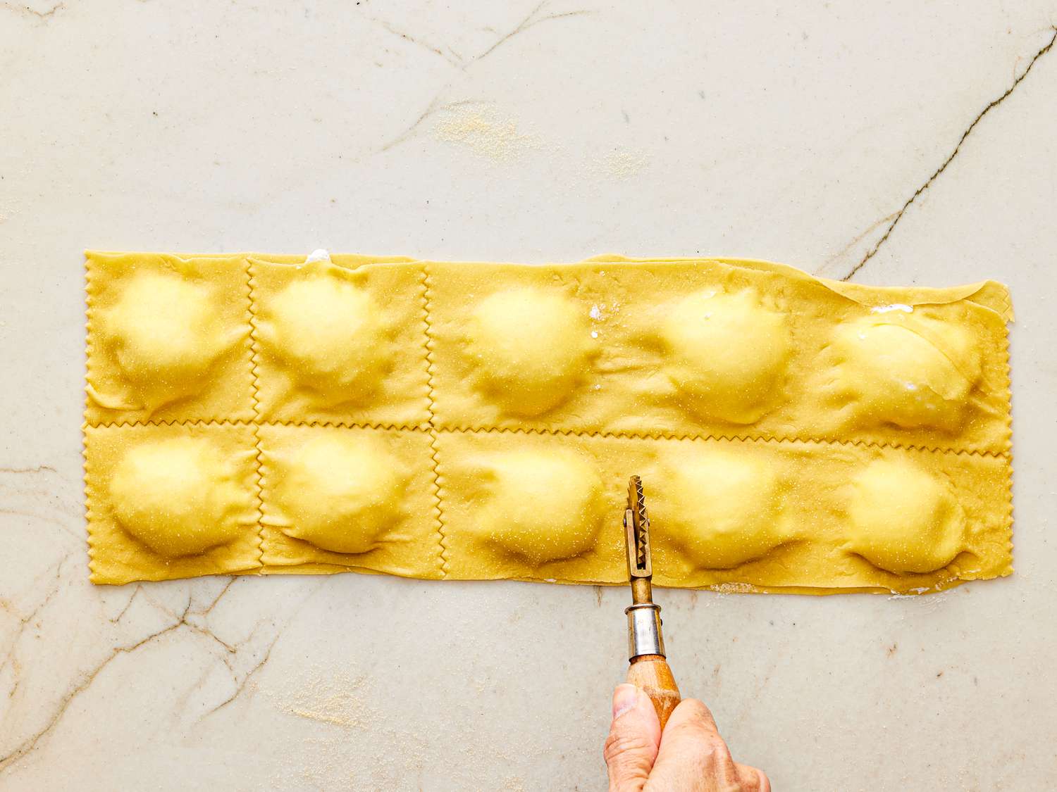 Overhead view of cutting raviolis 