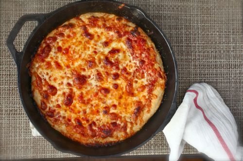 Greek-style pizza in a cast iron skillet. 