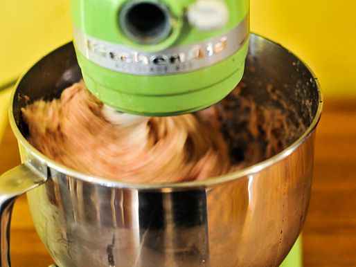 Blurred shot of the sausage being mixed on low speed in a stand mixer.
