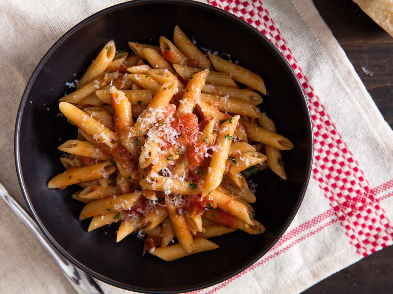 Overhead shot of a bowl of penne pasta with arrabbiata (spicy tomato) sauce.