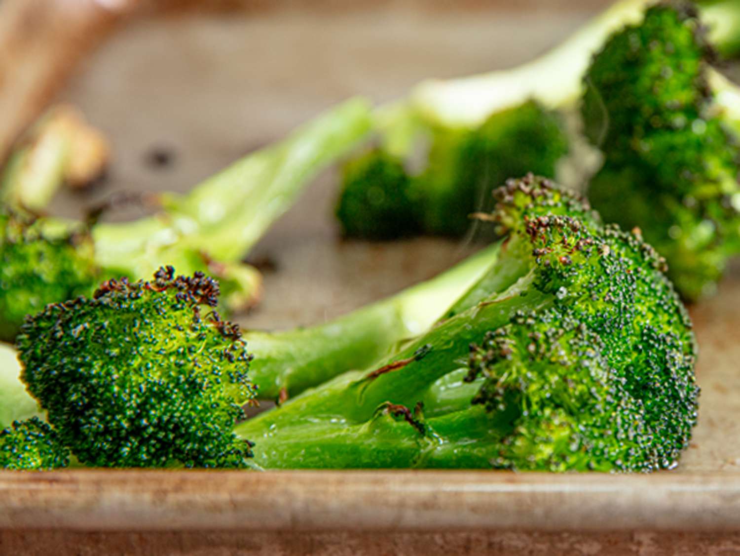 Roasted broccoli florets on a sheet pan