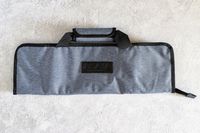Asaya Chef Knife Roll Bag with black handles and a visible Asaya brand logo on the front