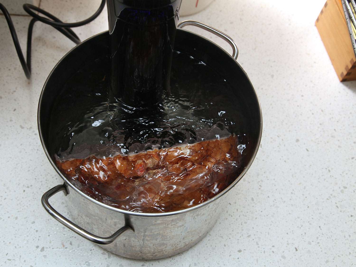 Ham being sous vide in a cooker.