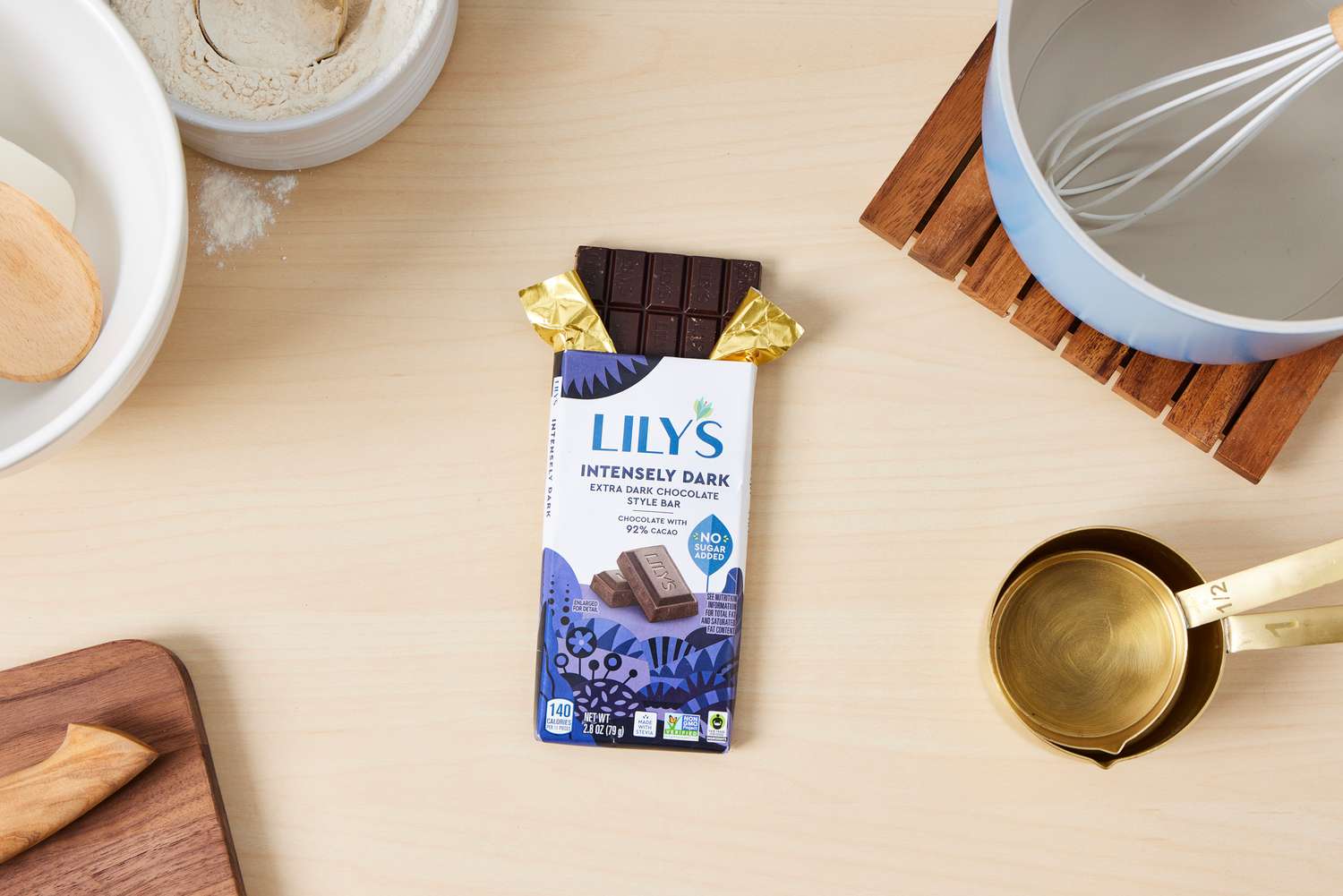 A partially unwrapped Lily's extra-dark chocolate bar.