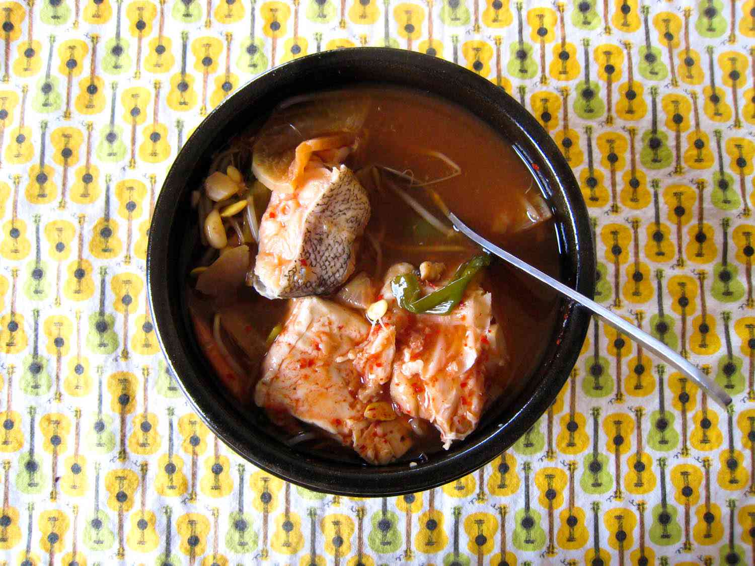 a clay pot of maeuntang with serving spoon