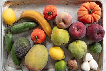 A sheet pan with frozen fruits and vegetables