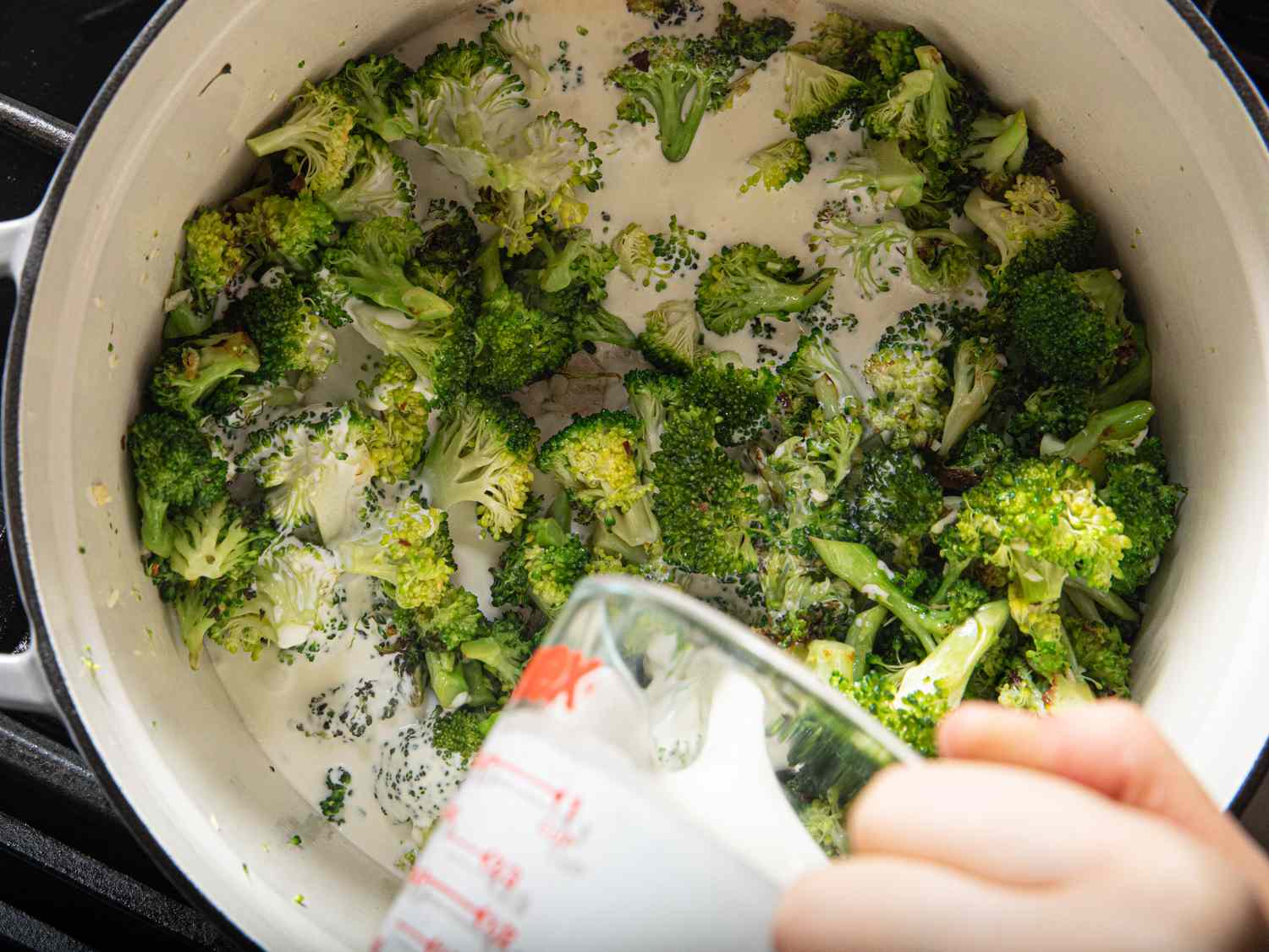 Broccoli with heavy cream in a Dutch oven