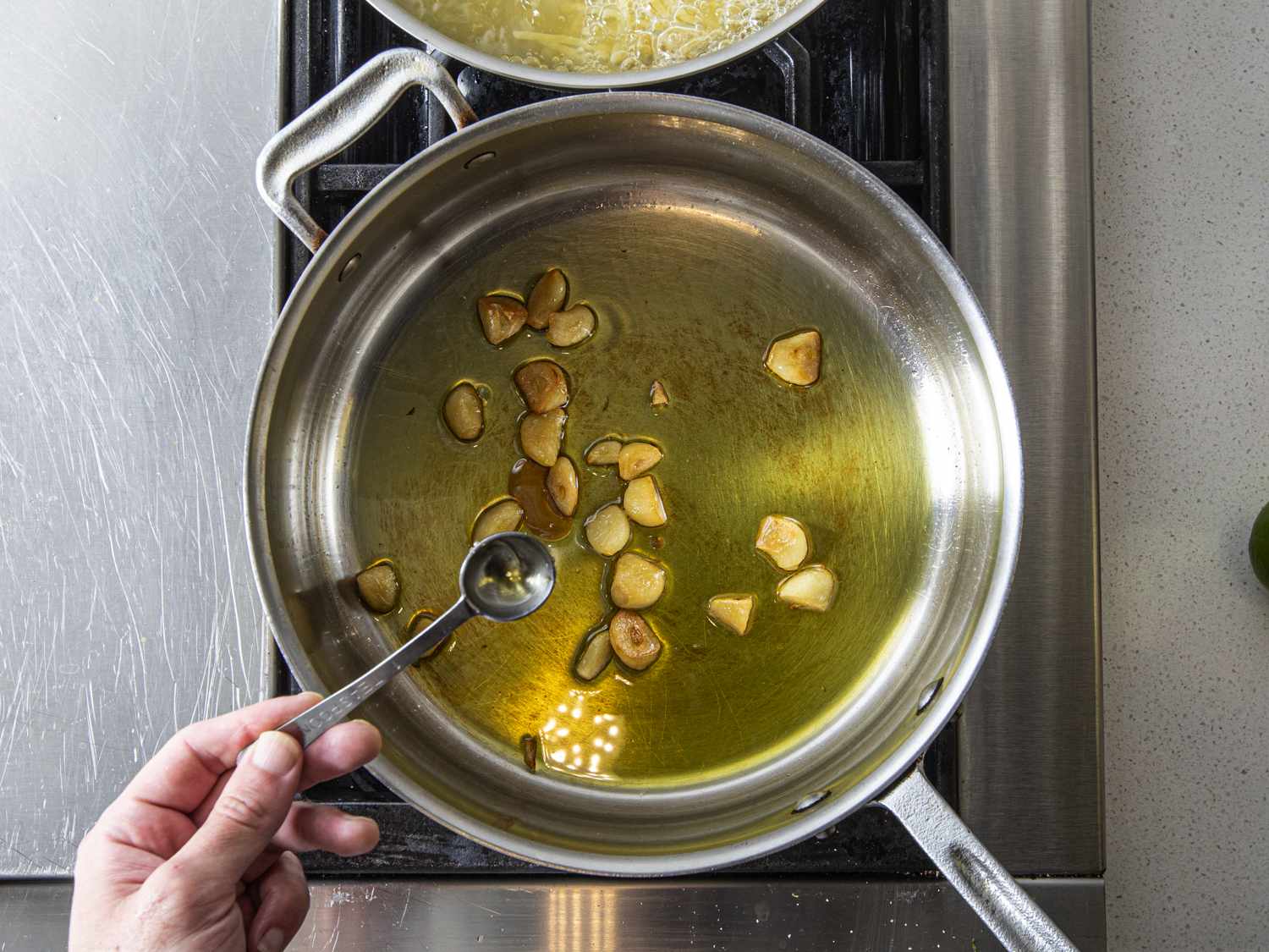 honey being added to garlic in oil