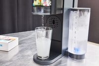 Ninja Thirsti Drink System dispensing a drink into a glass