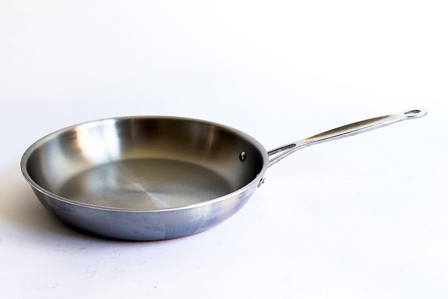 A pan from the Goldilocks 7-piece Cookware Set on a white surface