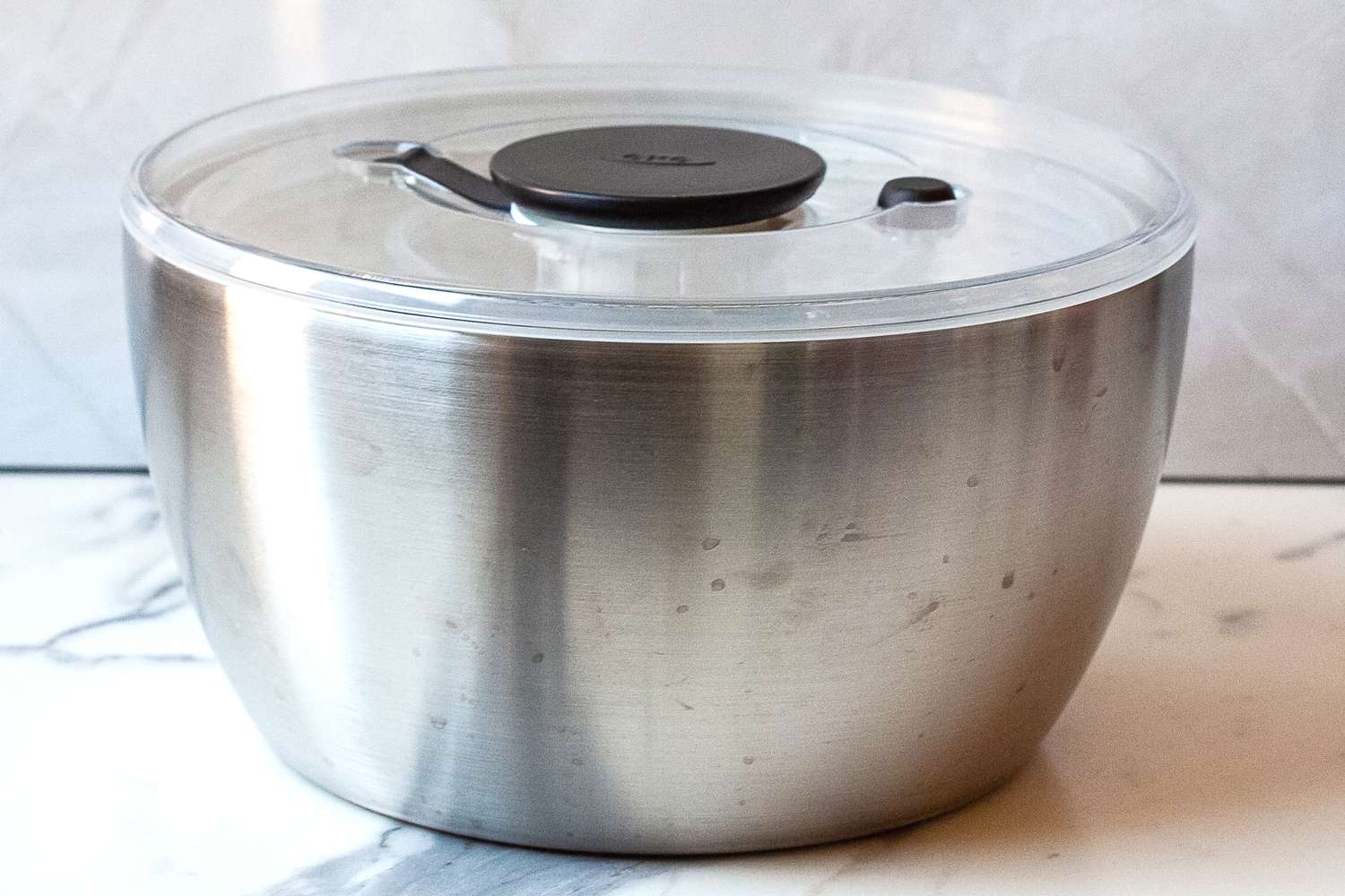 a close up of the oxo steel salad spinner