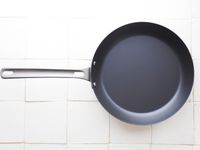 misen carbon steel pan on a white tile surface