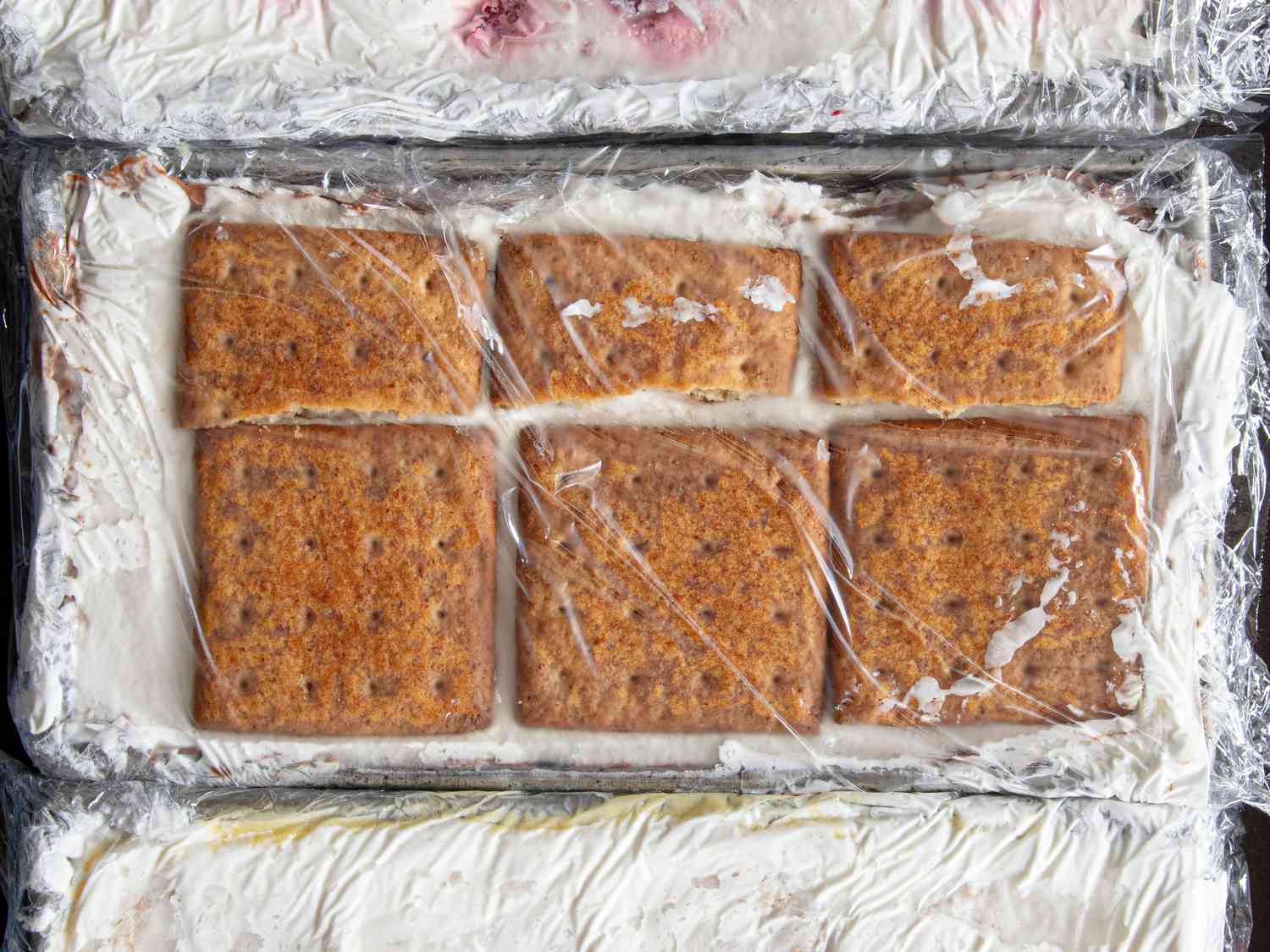Overhead view of icebox cake in plastic wrap