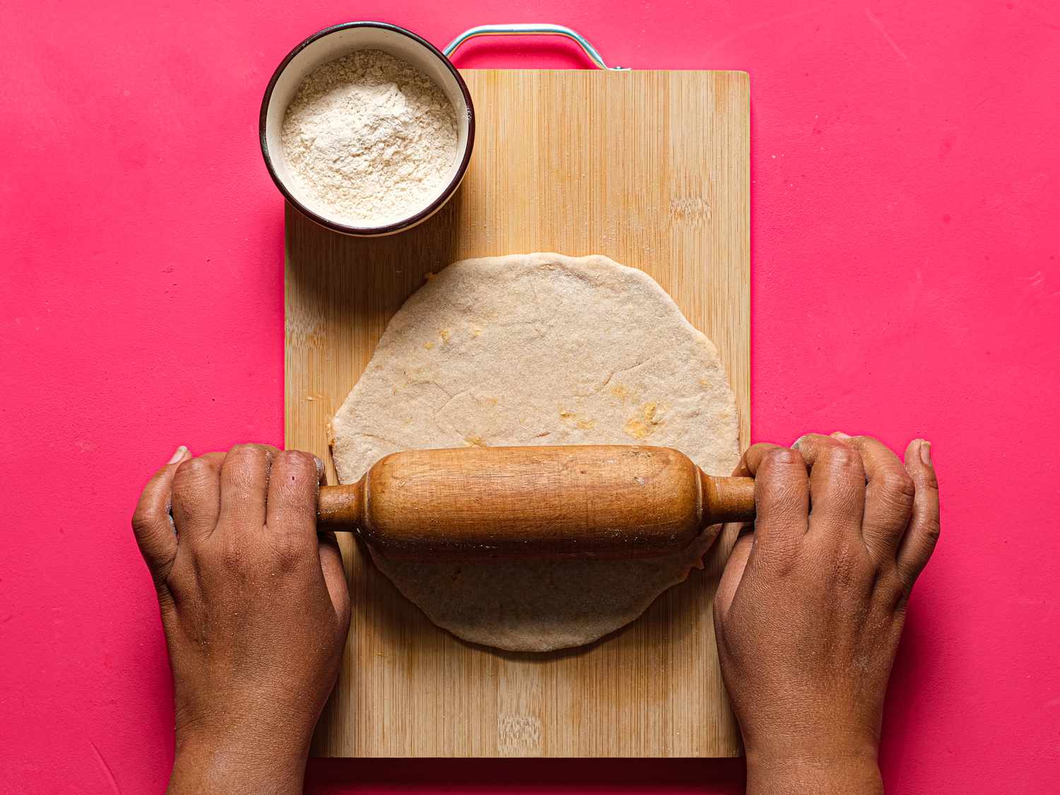 Overhead of rolling out stuffed dough