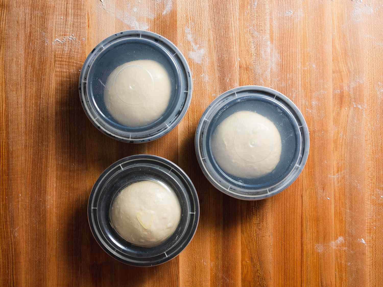 Pizza dough balls proofing in individual containers