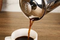 Person pouring coffee into cup with Espro P7 French Press