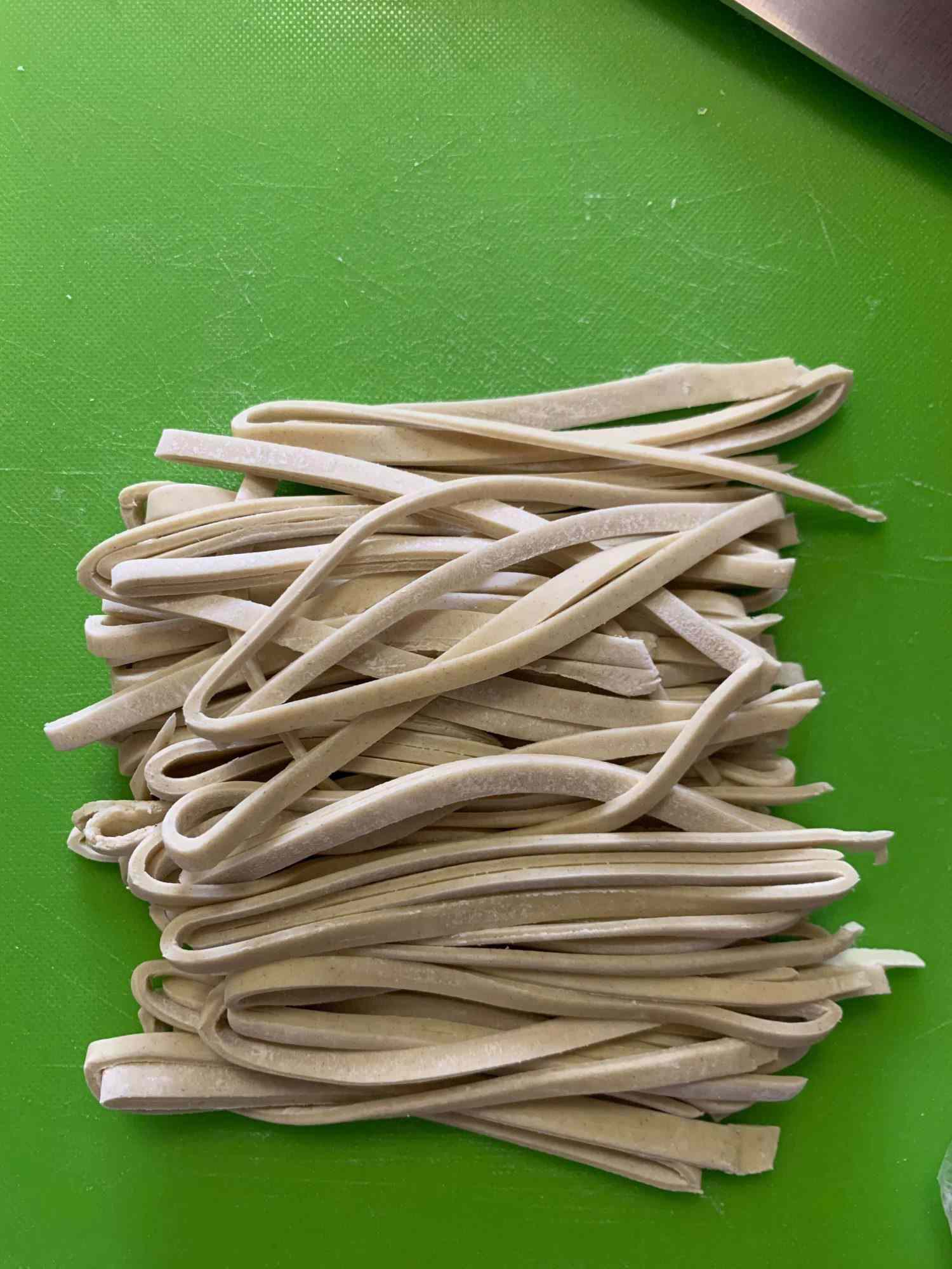 fresh ramen noodles post cutting on a cutting board